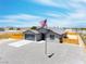 Beautiful single-story home with a spacious driveway and a flag proudly displayed in the well-maintained front yard at 1500 E Laguna St, Pahrump, NV 89048