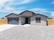 Charming single-story home with a two-car garage, desert landscaping, and inviting front entrance at 1500 E Laguna St, Pahrump, NV 89048