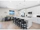 Modern kitchen featuring an oversized island, sleek white cabinetry, pendant lighting and stainless steel appliances at 1500 E Laguna St, Pahrump, NV 89048