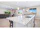 Open concept kitchen with island, breakfast bar, and stylish pendant lights, seamlessly connecting to the living space at 1500 E Laguna St, Pahrump, NV 89048