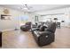 Open-concept living room flows into the kitchen with hardwood floors and comfortable leather seating at 1500 E Laguna St, Pahrump, NV 89048