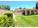 Spacious backyard with lush lawn featuring a covered patio and privacy wall at 1536 Brocado Ln, Las Vegas, NV 89117