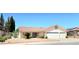 Single-story home featuring a red tile roof, three-car garage, and low-maintenance desert landscaping at 1536 Brocado Ln, Las Vegas, NV 89117