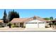 Charming single-story home featuring a red tile roof, three-car garage, and desert landscaping at 1536 Brocado Ln, Las Vegas, NV 89117