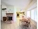 Cozy living room with a brick fireplace, seamlessly connecting to the kitchen and dining area at 1536 Brocado Ln, Las Vegas, NV 89117