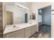 Bright bathroom featuring double sinks and arched window leading to the bedroom at 1740 Leaning Pine Way, Las Vegas, NV 89128
