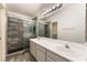 Bathroom boasting double sinks, sleek shower with glass enclosure, and stylish tiling at 1740 Leaning Pine Way, Las Vegas, NV 89128