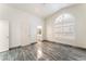 Bright bedroom with a large arched window, neutral walls, and stylish marble floors at 1740 Leaning Pine Way, Las Vegas, NV 89128