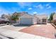 Charming single-story home with an attached garage and well-maintained landscaping on a sunny day at 1740 Leaning Pine Way, Las Vegas, NV 89128