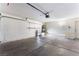 Spacious garage with ample storage space and clean concrete flooring for a tidy appearance at 1740 Leaning Pine Way, Las Vegas, NV 89128
