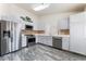 Updated kitchen with stainless steel appliances, sleek white cabinetry, and stylish marble floors at 1740 Leaning Pine Way, Las Vegas, NV 89128