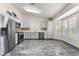 Updated kitchen with stainless steel appliances, white cabinets, and stylish marble floors at 1740 Leaning Pine Way, Las Vegas, NV 89128