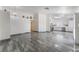 Bright living room with high ceilings, tile flooring, and seamless transition to a modern kitchen at 1740 Leaning Pine Way, Las Vegas, NV 89128