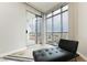 Relaxing chaise lounge by the windows offering views of the city from the bedroom at 200 W Sahara Ave # 910, Las Vegas, NV 89102