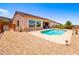 Private backyard with a sparkling pool, complemented by low-maintenance desert landscaping, perfect for relaxation at 2106 King Mesa Dr, Henderson, NV 89012