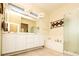 Bright bathroom featuring dual sinks, a vanity, and glass enclosed shower at 2106 King Mesa Dr, Henderson, NV 89012
