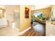 Bright bathroom showcasing a tub, separate shower, and a view of the outdoors at 2106 King Mesa Dr, Henderson, NV 89012
