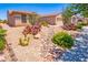 Lush desert landscaping including cacti and drought-tolerant shrubs decorate the front yard at 2106 King Mesa Dr, Henderson, NV 89012
