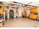 Two car garage with epoxy flooring, storage cabinets, and work area at 2106 King Mesa Dr, Henderson, NV 89012