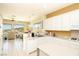 Bright kitchen features white cabinetry, tile floors, and views of the surrounding neighborhood at 2106 King Mesa Dr, Henderson, NV 89012