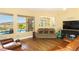 Cozy living room overlooking a pool and featuring hardwood floors and a comfortable sofa at 2106 King Mesa Dr, Henderson, NV 89012