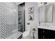 Modern bathroom featuring patterned tile shower, sleek fixtures, and decorative floral artwork at 2168 Big Bar Dr, Henderson, NV 89052