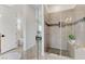 Modern bathroom featuring a tiled shower with a glass enclosure and a bench seat at 2168 Big Bar Dr, Henderson, NV 89052