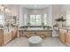 Luxurious bathroom featuring a soaking tub, natural light, and dual vanities with granite counters at 2168 Big Bar Dr, Henderson, NV 89052