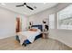 Stylish bedroom boasts a modern design with wood-look floors, a window, and an ensuite bathroom at 2168 Big Bar Dr, Henderson, NV 89052