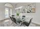 Dining space with glass table, modern chairs, and unique geometric mirror at 2168 Big Bar Dr, Henderson, NV 89052