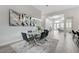 Dining space featuring a glass table, unique mirror accent, and modern lighting at 2168 Big Bar Dr, Henderson, NV 89052