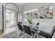 Elegant dining room featuring a glass table, stylish chairs, and a modern decorative mirror at 2168 Big Bar Dr, Henderson, NV 89052