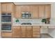 Modern kitchen with stainless steel appliances, tiled backsplash, and ample cabinet space at 2168 Big Bar Dr, Henderson, NV 89052