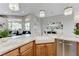 Modern kitchen with a farmhouse sink, stainless steel appliances, and granite countertops at 2168 Big Bar Dr, Henderson, NV 89052