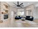 Spacious living room with fireplace, ceiling fan, and modern furnishings at 2168 Big Bar Dr, Henderson, NV 89052