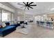 Open concept living room showcasing modern furnishings, tile floors and eat-in kitchen at 2168 Big Bar Dr, Henderson, NV 89052