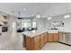Open-concept kitchen flowing into the living room with a stone fireplace at 2168 Big Bar Dr, Henderson, NV 89052