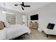Spacious primary bedroom featuring herringbone floors, a TV, and an attached closet at 2168 Big Bar Dr, Henderson, NV 89052
