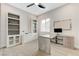 Bright home office features built-in shelving, a modern desk, and wood-look floors at 2168 Big Bar Dr, Henderson, NV 89052