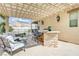 Outdoor kitchen, seating area, and pool with fence at 2168 Big Bar Dr, Henderson, NV 89052
