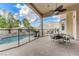 View of pool, surrounding palms and covered patio with dining furniture at 2168 Big Bar Dr, Henderson, NV 89052