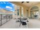 Covered patio features a dining table and chairs with view of pool and exterior of the home at 2168 Big Bar Dr, Henderson, NV 89052