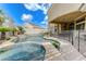 Covered patio with pool and spa is ideal for outdoor entertaining, with desert landscaping and privacy walls at 2168 Big Bar Dr, Henderson, NV 89052