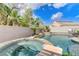Private backyard oasis with a sparkling pool, spa, and mature tropical landscaping offers resort-style living at 2168 Big Bar Dr, Henderson, NV 89052