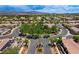 Aerial view of the neighborhood showcasing tree-lined streets and well-maintained homes with tile roofs at 2177 Hidden Ranch Ter, Henderson, NV 89052