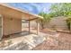 Backyard featuring covered patio, rock landscaping, and block wall fence at 2177 Hidden Ranch Ter, Henderson, NV 89052