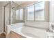 This bathroom is brightly lit and features a stand up shower and a large soaking tub at 2177 Hidden Ranch Ter, Henderson, NV 89052