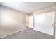 Neutral bedroom featuring a closet and door to another room with neutral carpet at 2177 Hidden Ranch Ter, Henderson, NV 89052