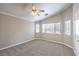Spacious carpeted bedroom featuring a ceiling fan and multiple windows for natural light at 2177 Hidden Ranch Ter, Henderson, NV 89052
