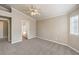 This cozy bedroom has a neutral color palette, plush carpet, and has an attached bathroom and walk in closet at 2177 Hidden Ranch Ter, Henderson, NV 89052